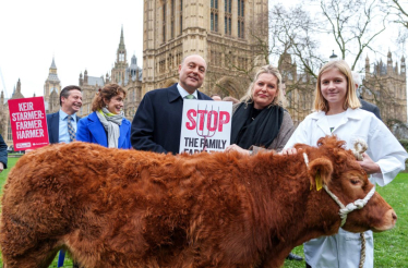 Mims Davies MP with Family Farmers and Vicky the cow outside Parliament against FamilyFarmTax